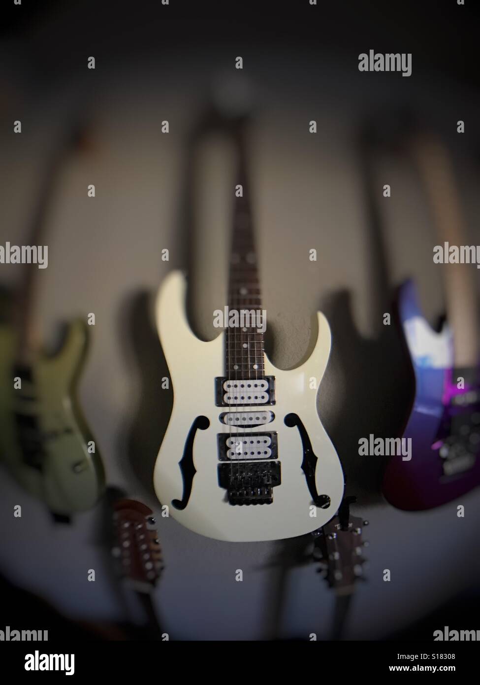 Wide angle view of electric guitars hanging on a wall - Smartphone Captured Stock Image