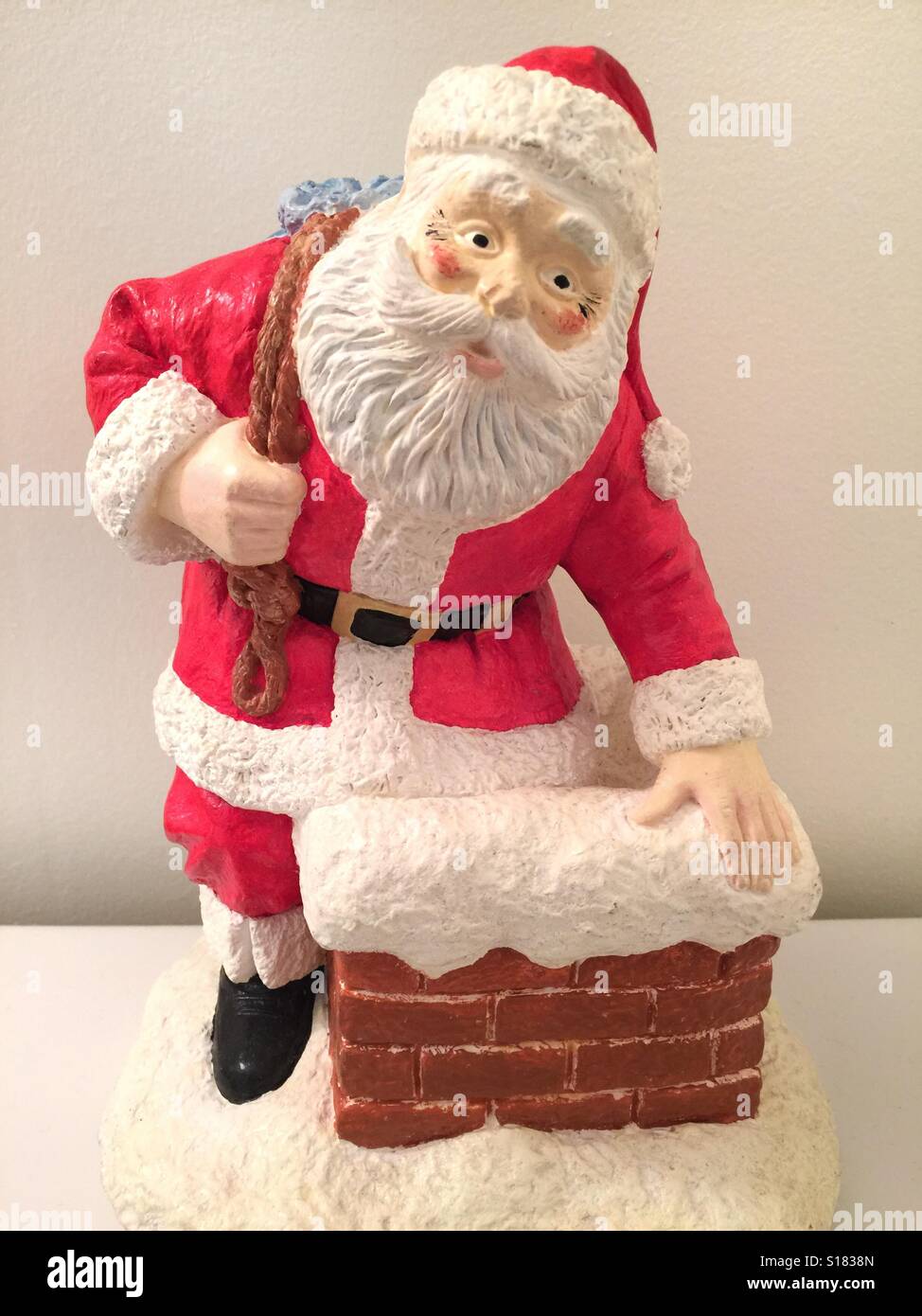 A Santa Claus figurine against a white background Stock Photo