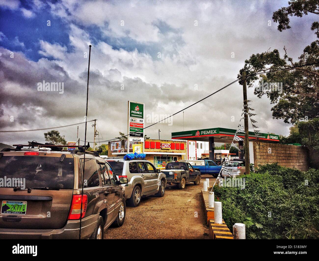 Cars wait in a long line for gas on december 30 2016 in one of the few