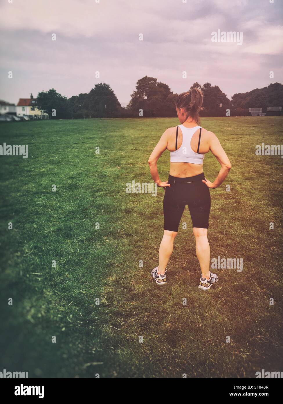 Woman resting after exercising in a park - Smartphone Captured Stock Image