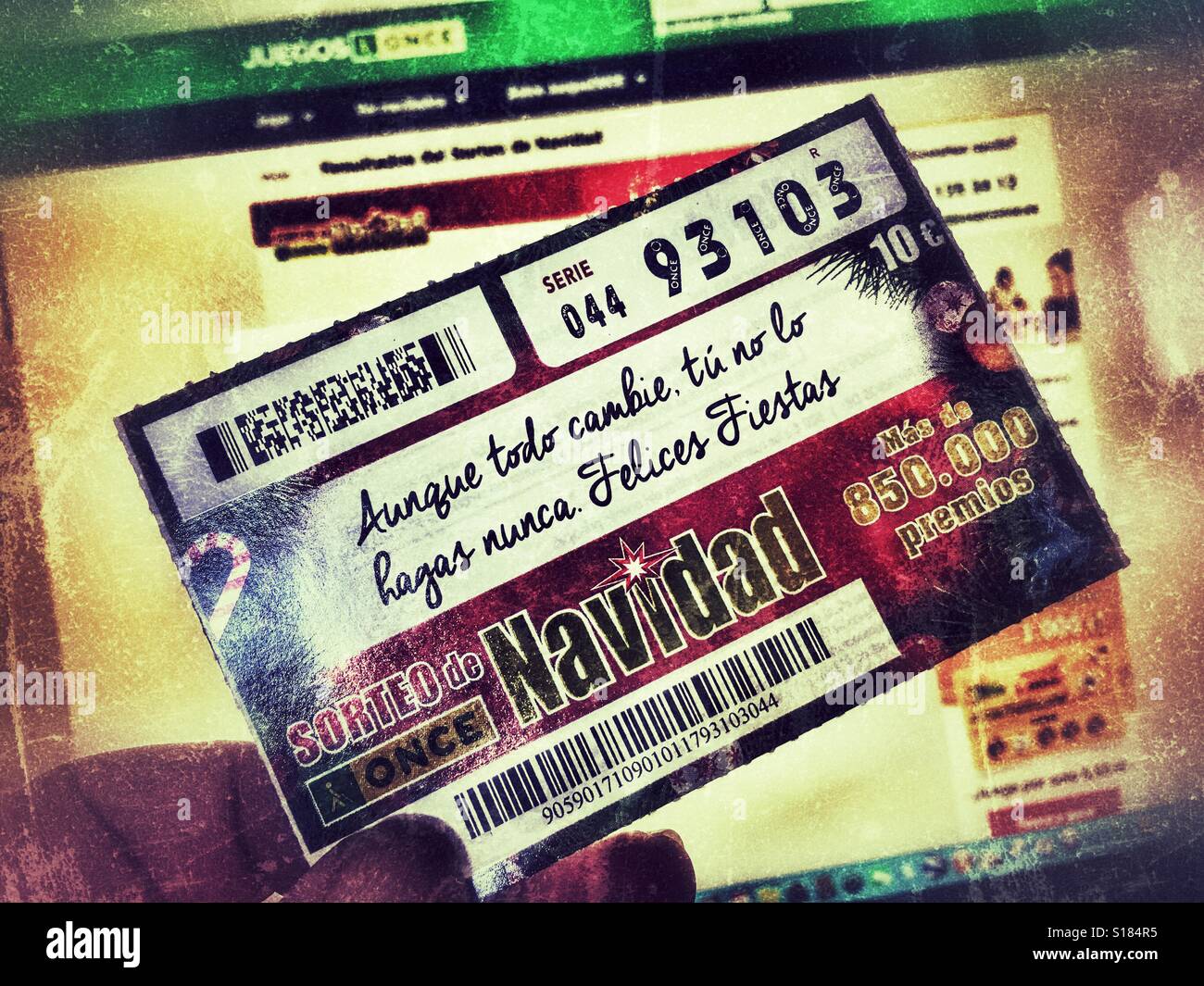 Checking Spanish Christmas lottery ticket on computer. Once ticket in hand - Smartphone Captured Stock Image