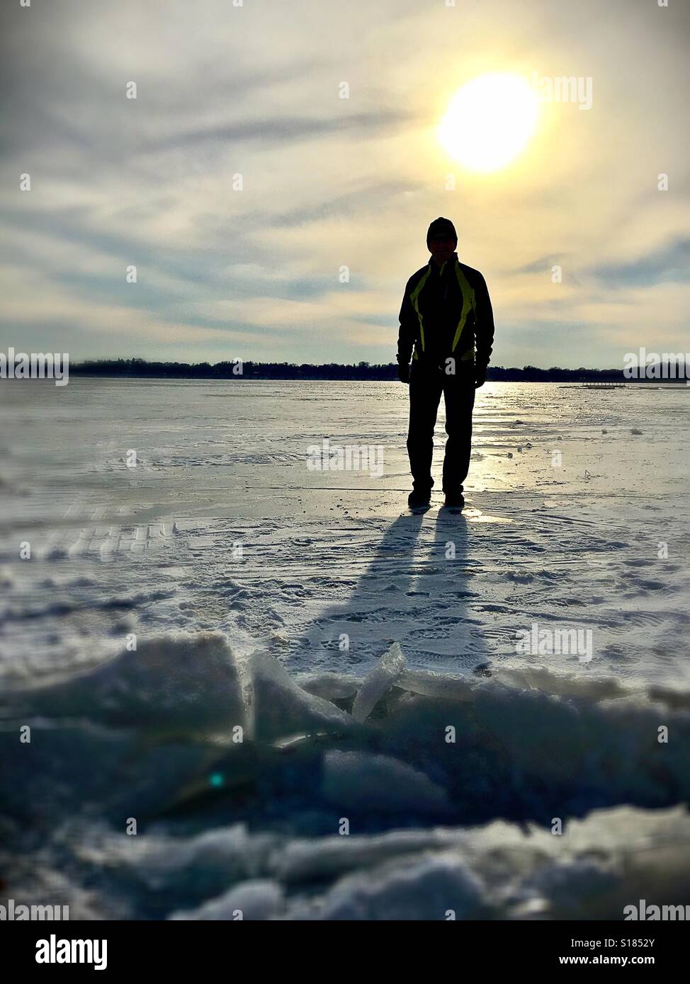 A man standing on a frozen lake. Stock Photo