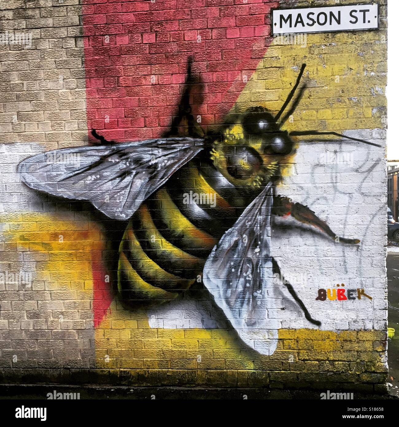 Bee graffiti art in Manchester, UK Stock Photo