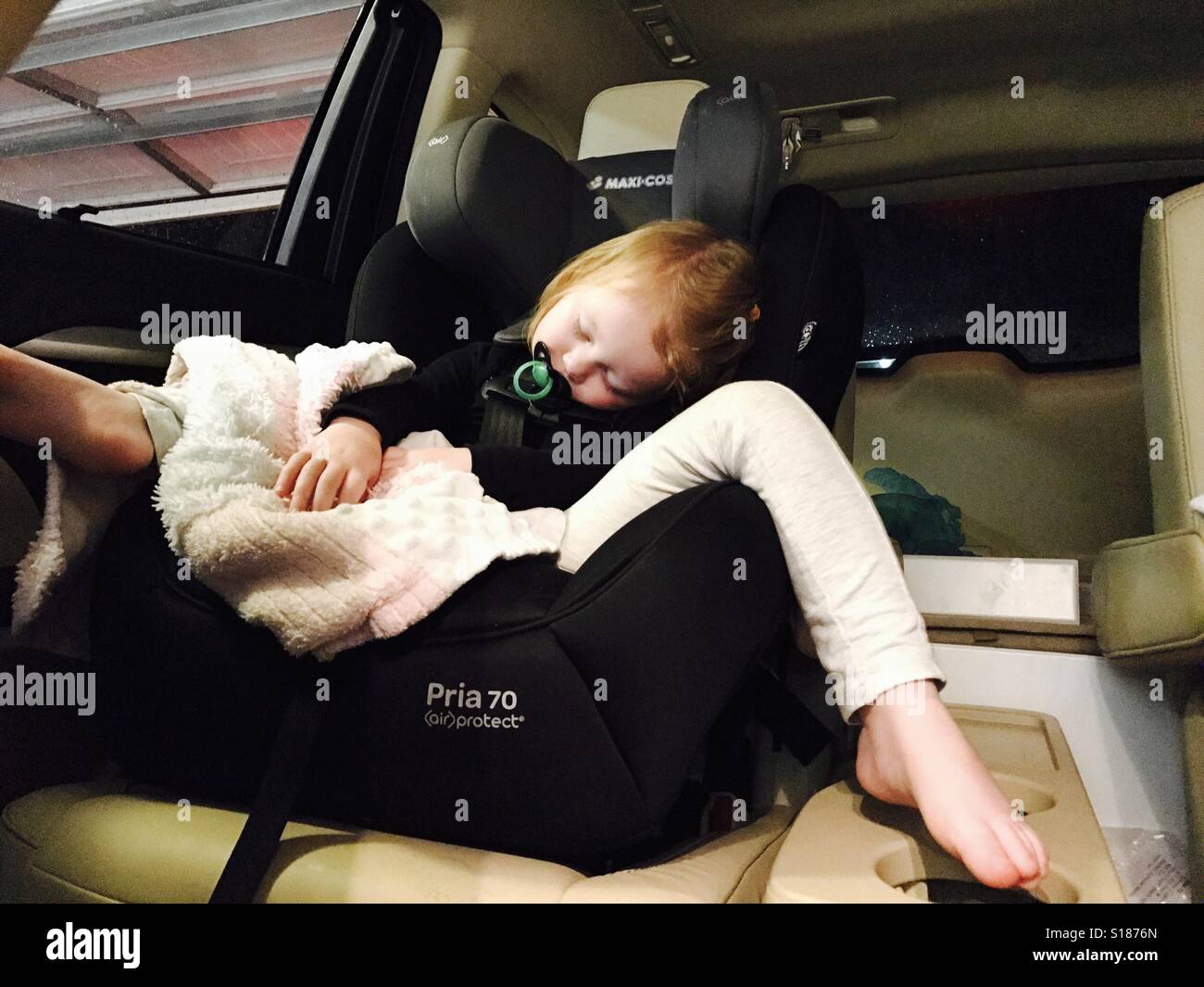 Toddler sleeping in Joie Trillo Shield Car Seat Stock Photo - Alamy