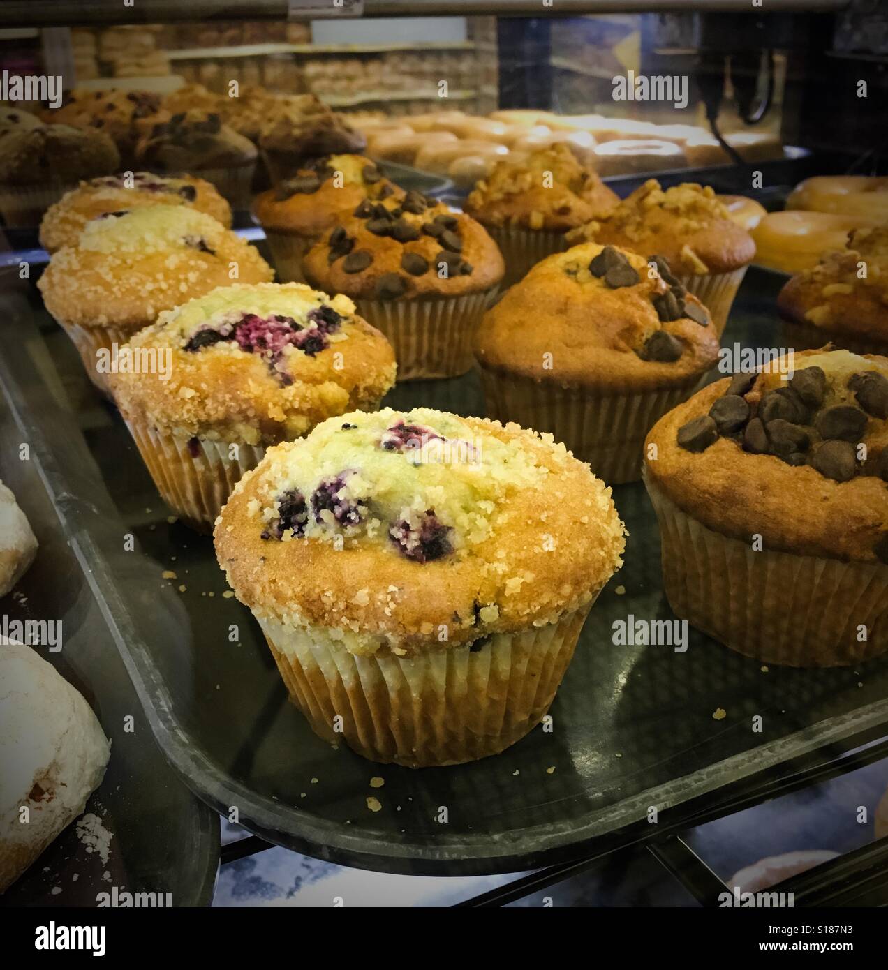 Muffins on a tray in a grocery store bakery Stock Photo Alamy