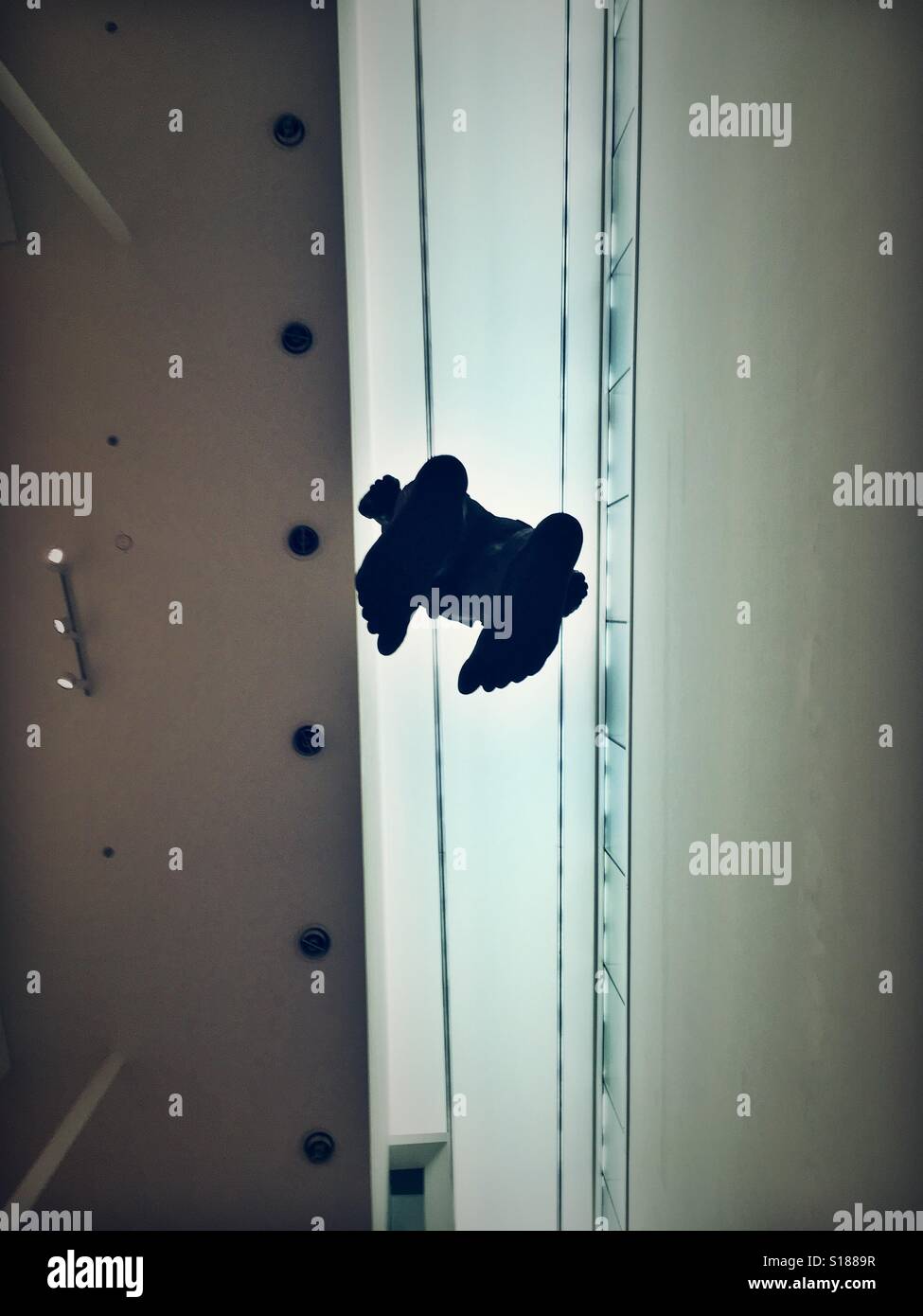 Hanging Anthony Gormley sculpture hanging in the National Portrait Gallery in London - Smartphone Captured Stock Image