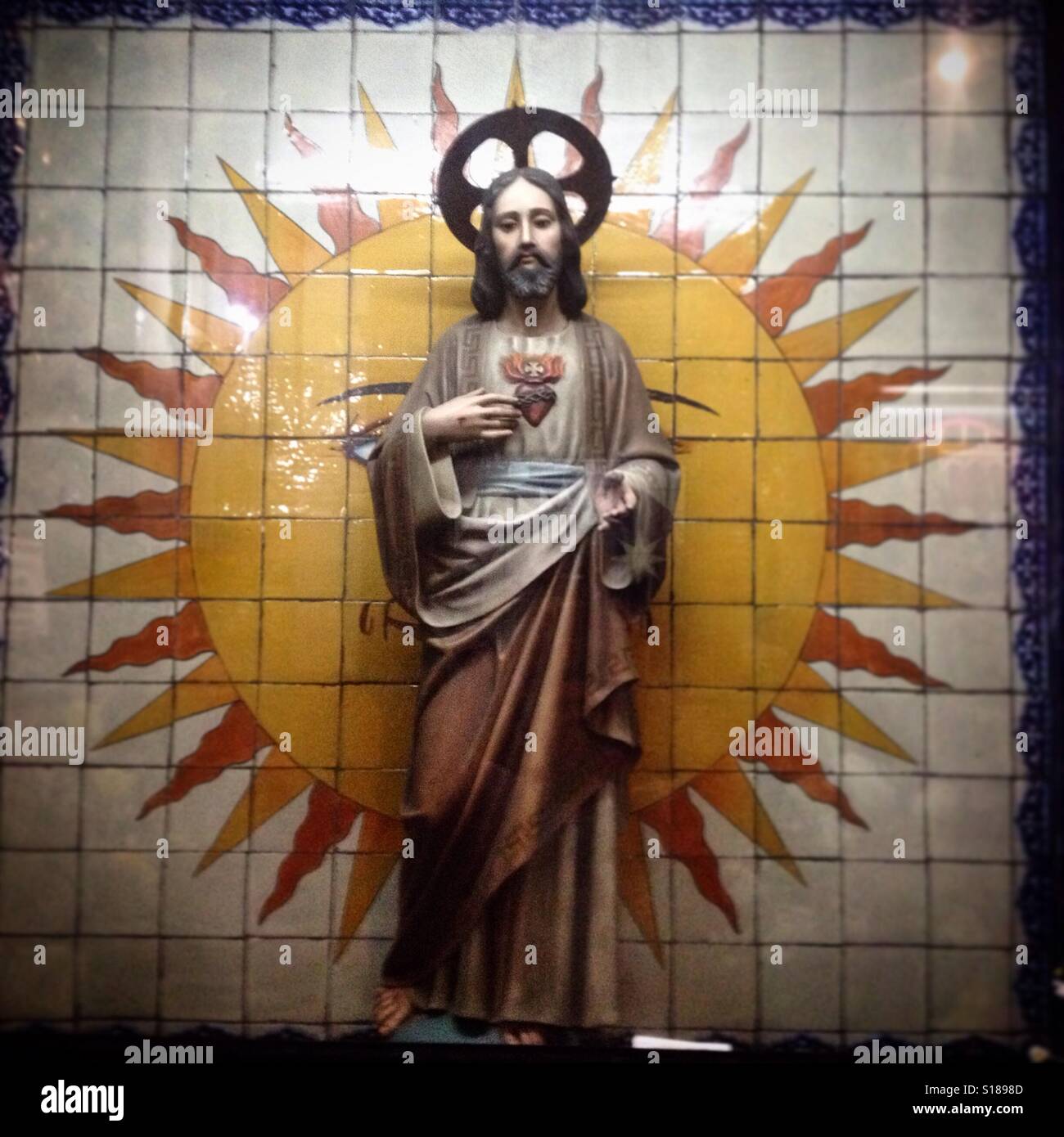 An image of the Sacred Heart of Jesus in front of a sun made with ceramic tiles decorates the Capilla del Cerrito of the Basilica o Guadalupe in Mexico City, Mexico Stock Photo