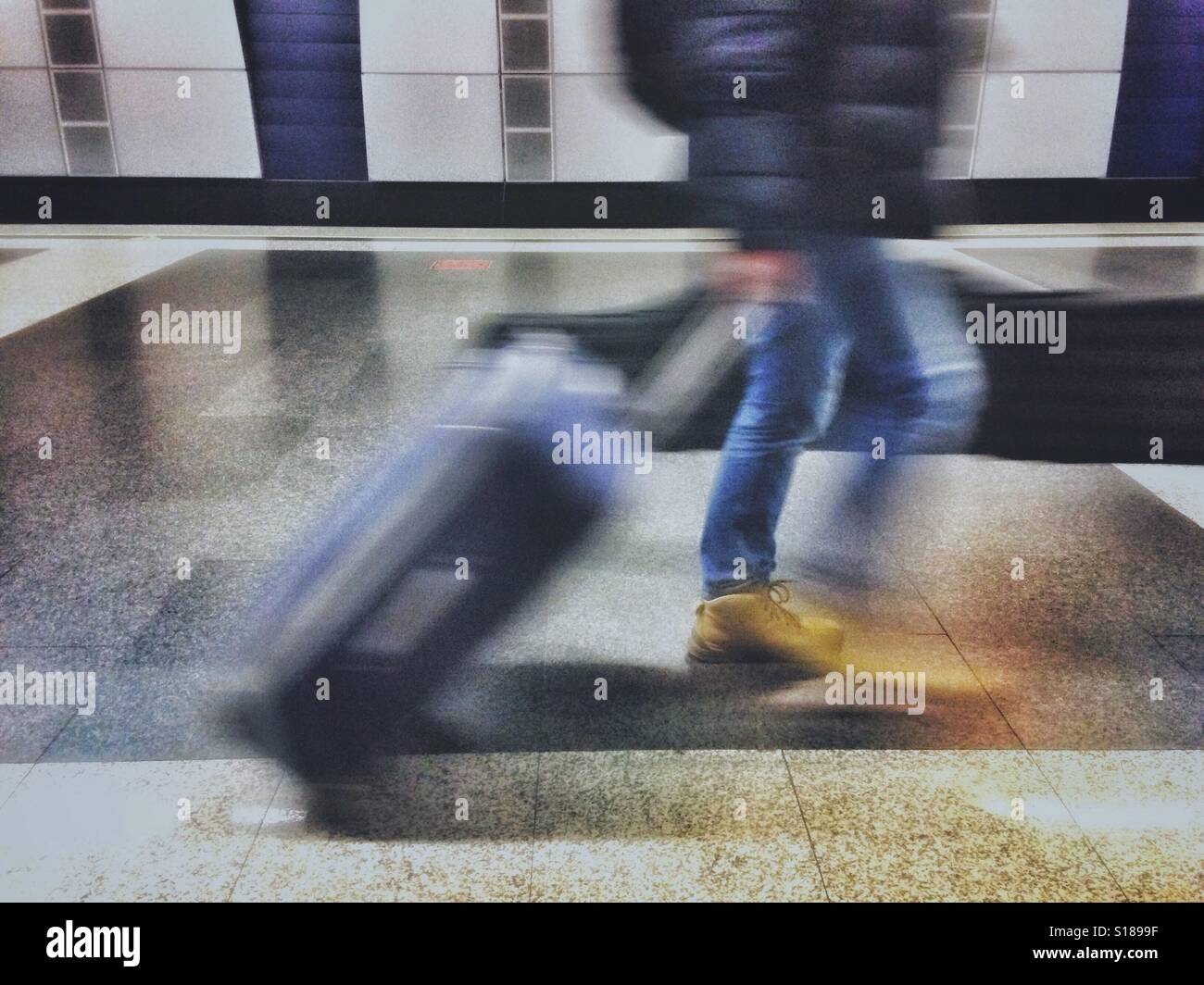 Moving blur of a person walking with a suitcases - Smartphone Captured Stock Image