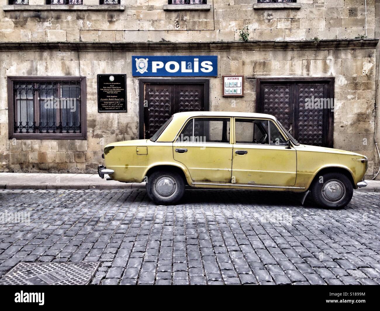 Police station and yellow car in front in old city Baku, Azerbaijan - Smartphone Captured Stock Image