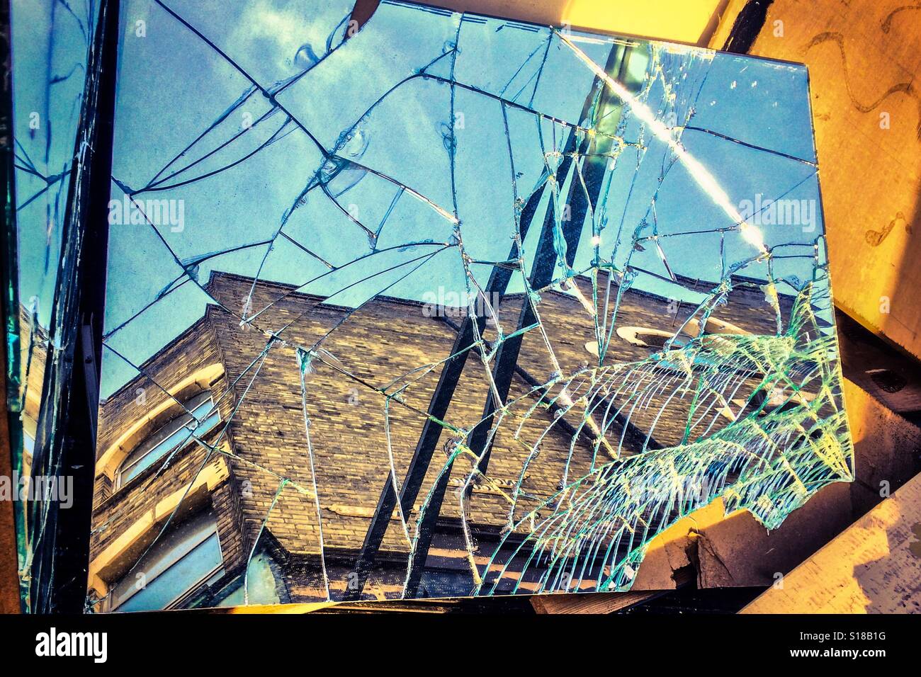 Shattered mirror reflects building - Smartphone Captured Stock Image