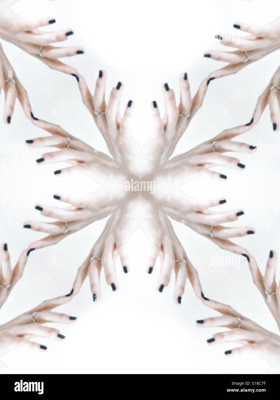 An abstract conceptual image of a repetitive design. Created from female fingers against a white background Stock Photo