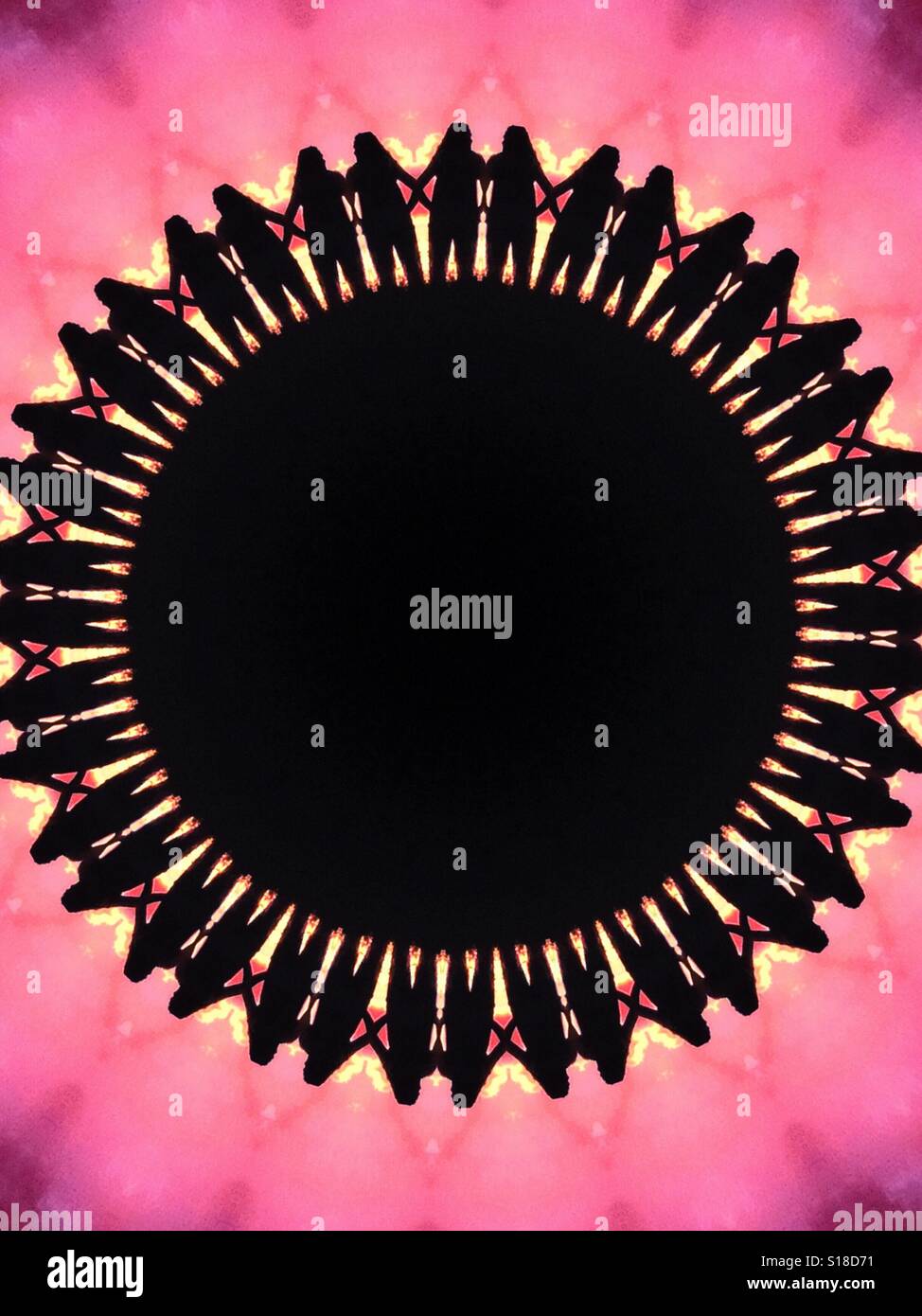 A large circle featuring the silhouetted of many people standing next to each other, against a bright pink background - Smartphone Captured Stock Image