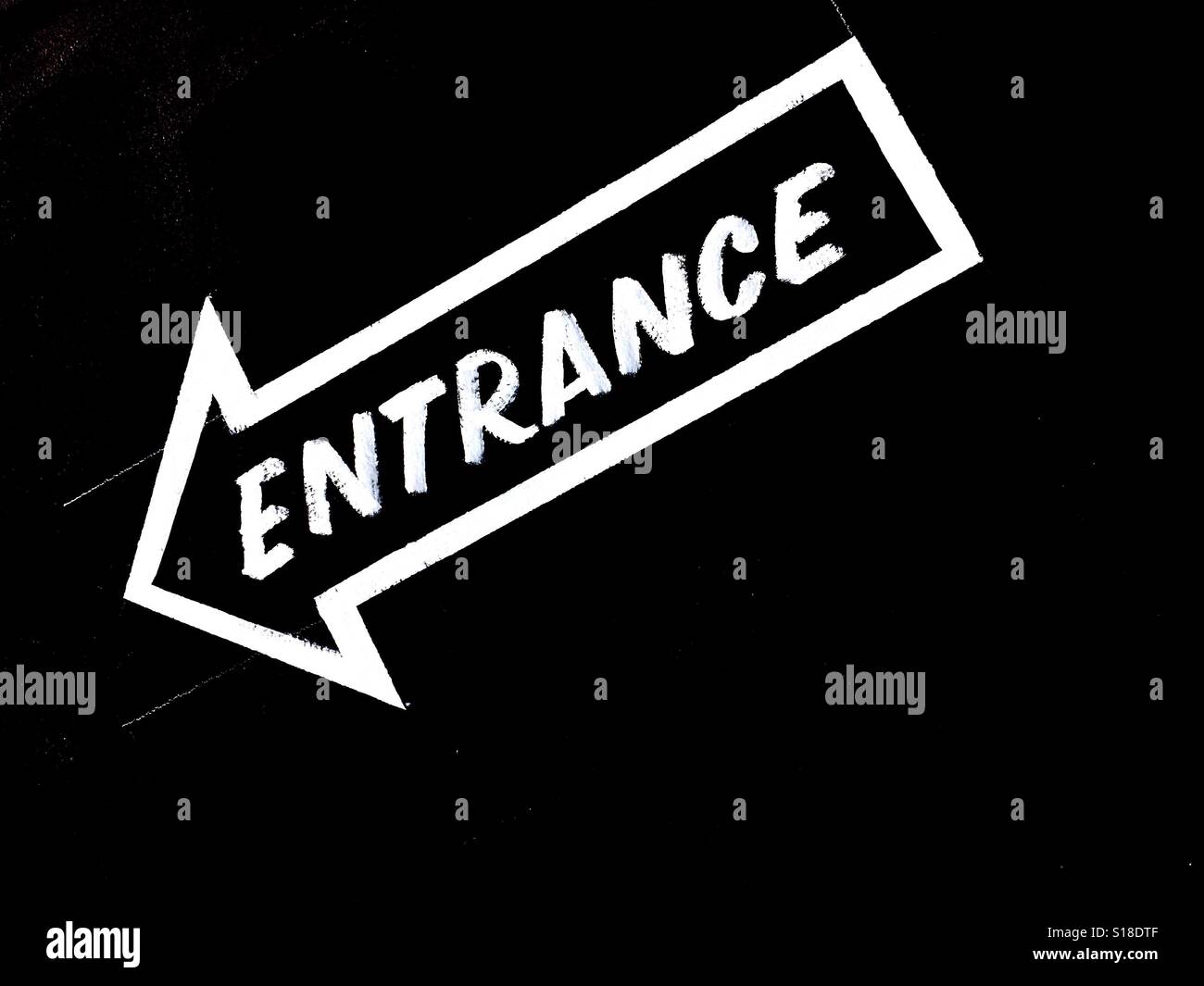 Hand lettered entrance arrow - Smartphone Captured Stock Image