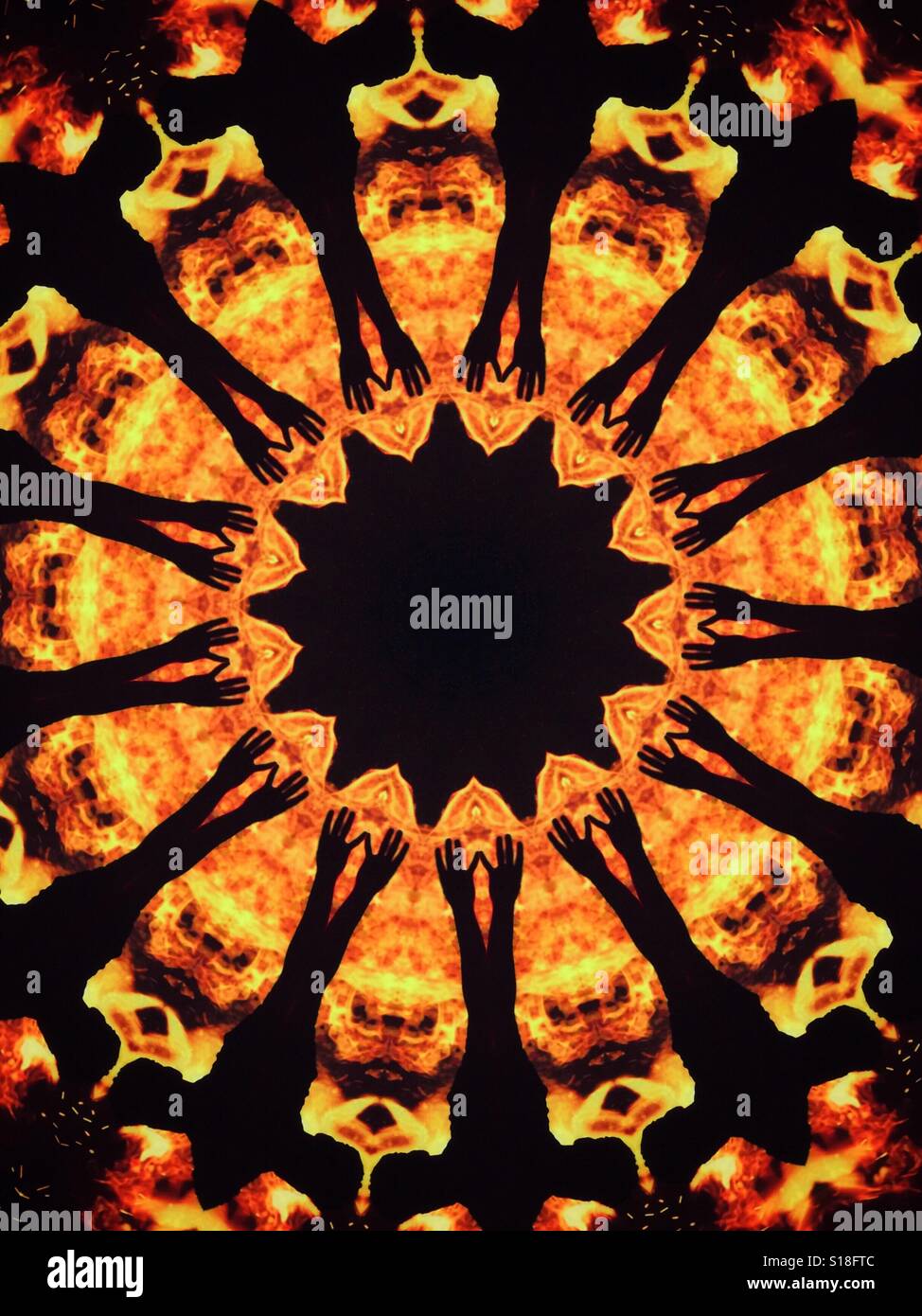 A kaleidoscopic image of flames and fire with the silhouette of outstretched hands - Smartphone Captured Stock Image