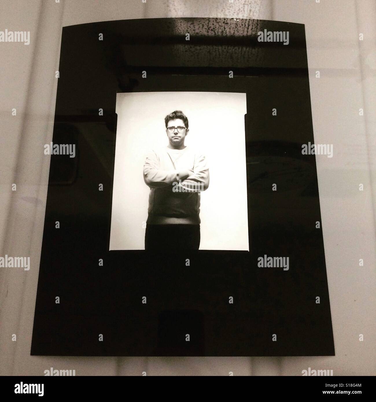 Black and white large format 5x4' self portrait photographic print, in the darkroom wash. Stock Photo