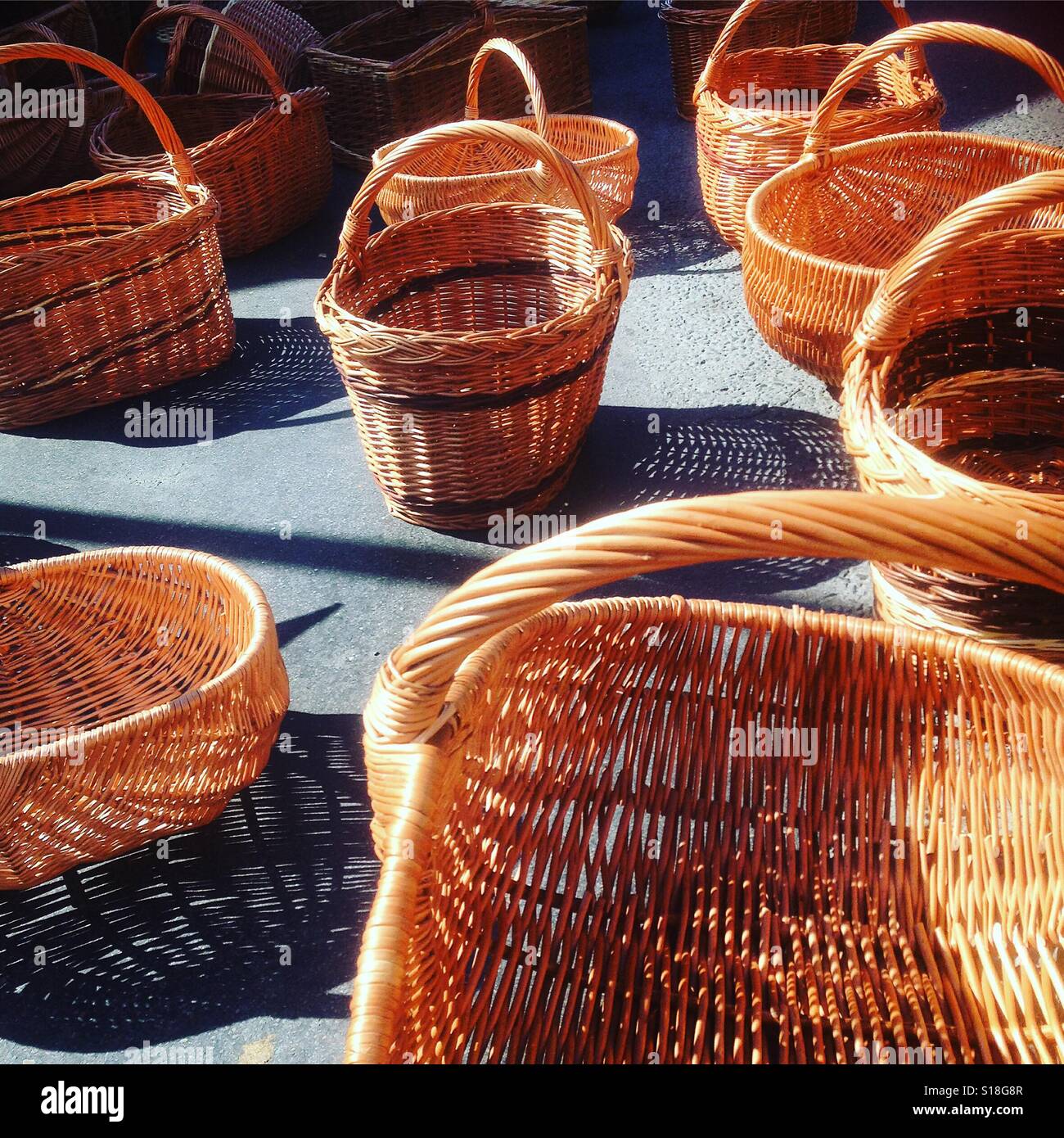 Wicker shopping baskets for sale on a French street market stall - Smartphone Captured Stock Image