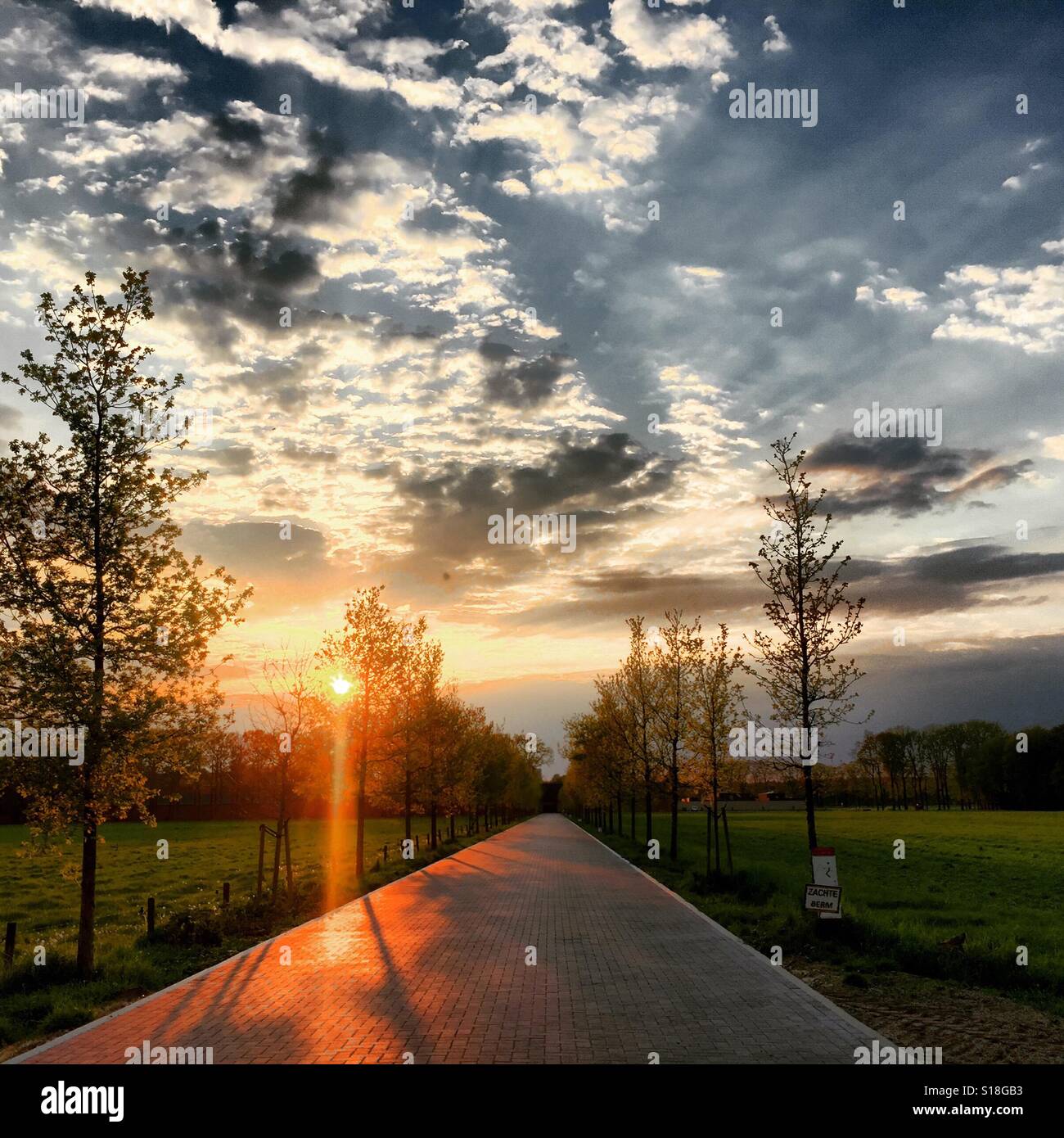Paved road under a dramatic sky Stock Photo - Alamy