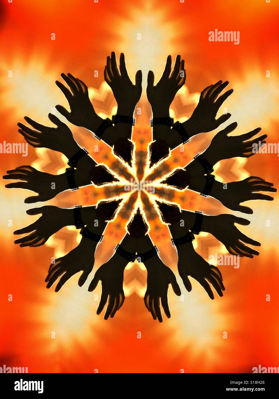 An abstract kaleidoscopic image featuring silhouetted hands on a fiery orange background Stock Photo