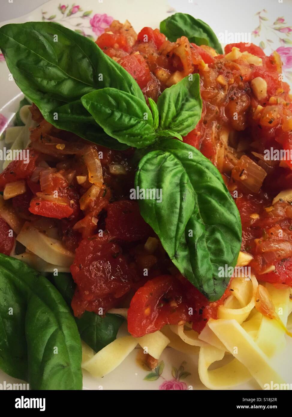 Lynn Greenie pasta dish with homemade Marinara sauce and fresh basil topping - Smartphone Captured Stock Image