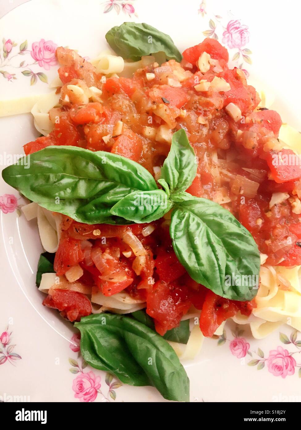 Lynn Greenie pasta dish with homemade marinara sauce and fresh basil - Smartphone Captured Stock Image