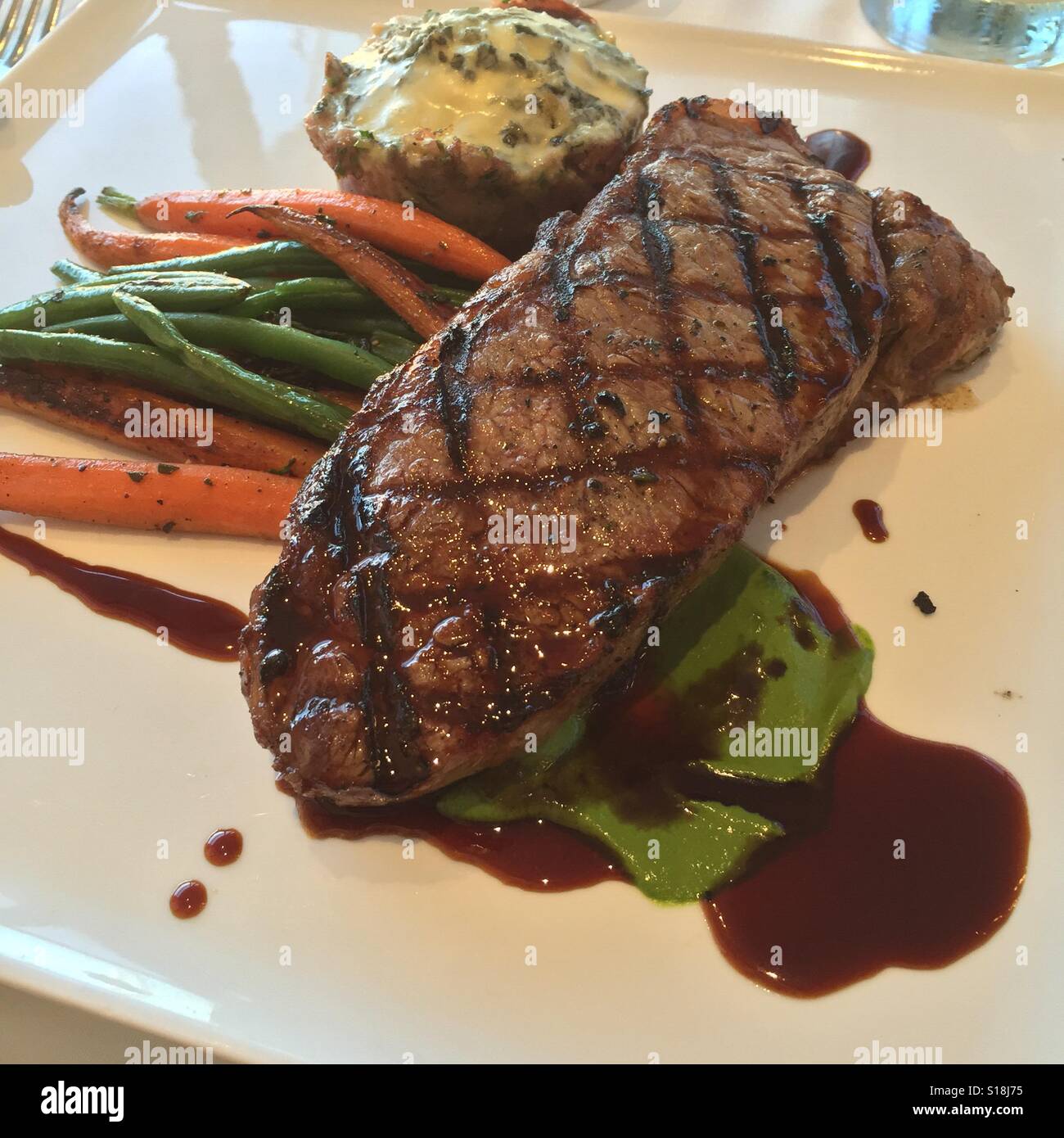 Dinner steak carrots green beans mash potatoes dinner plate Stock Photo
