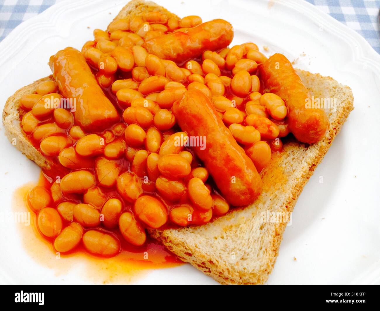 Heinz baked beans with pork sausages on toast Stock Photo Alamy