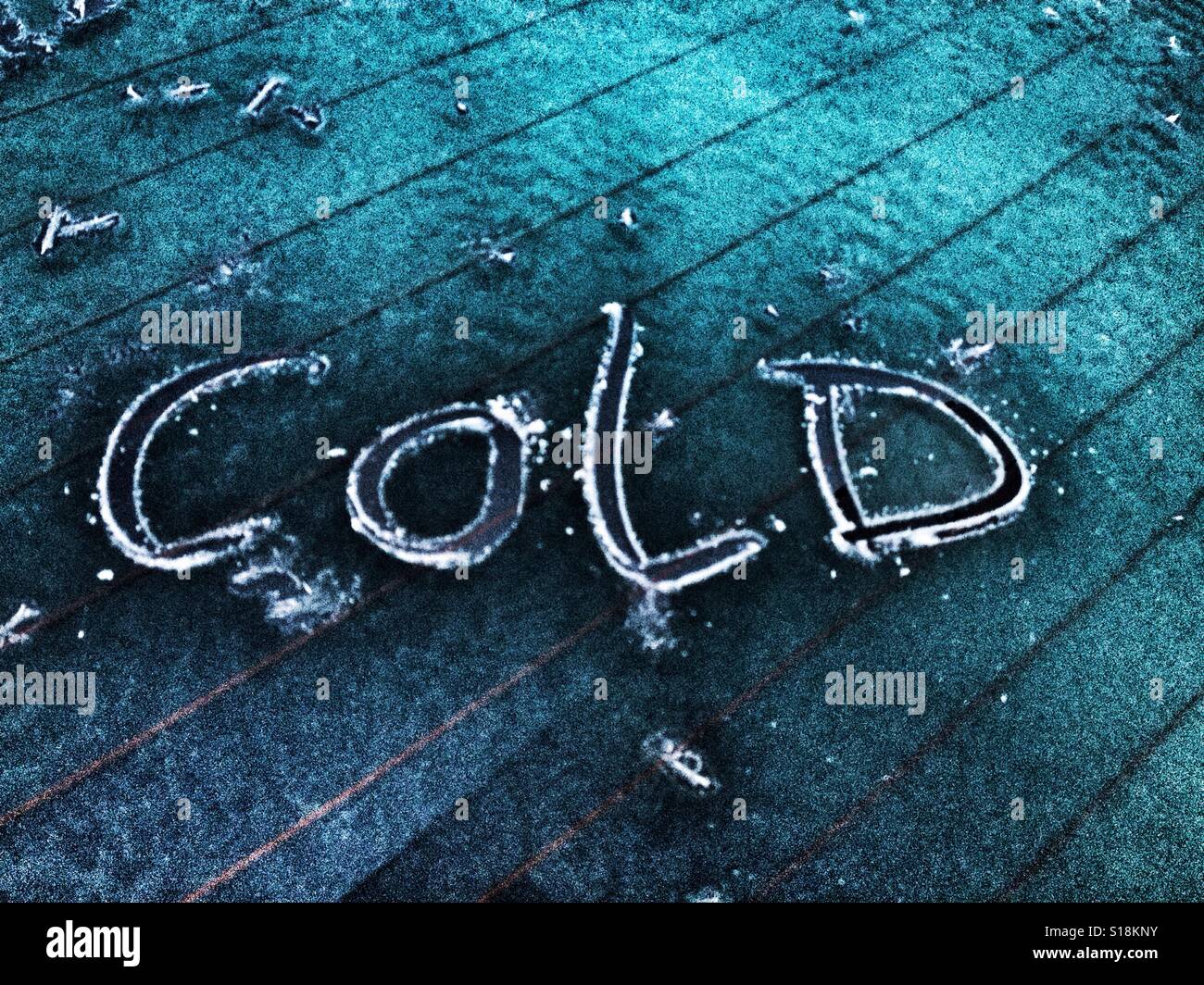 Text Cold written in ice on a car rear window - Smartphone Captured Stock Image