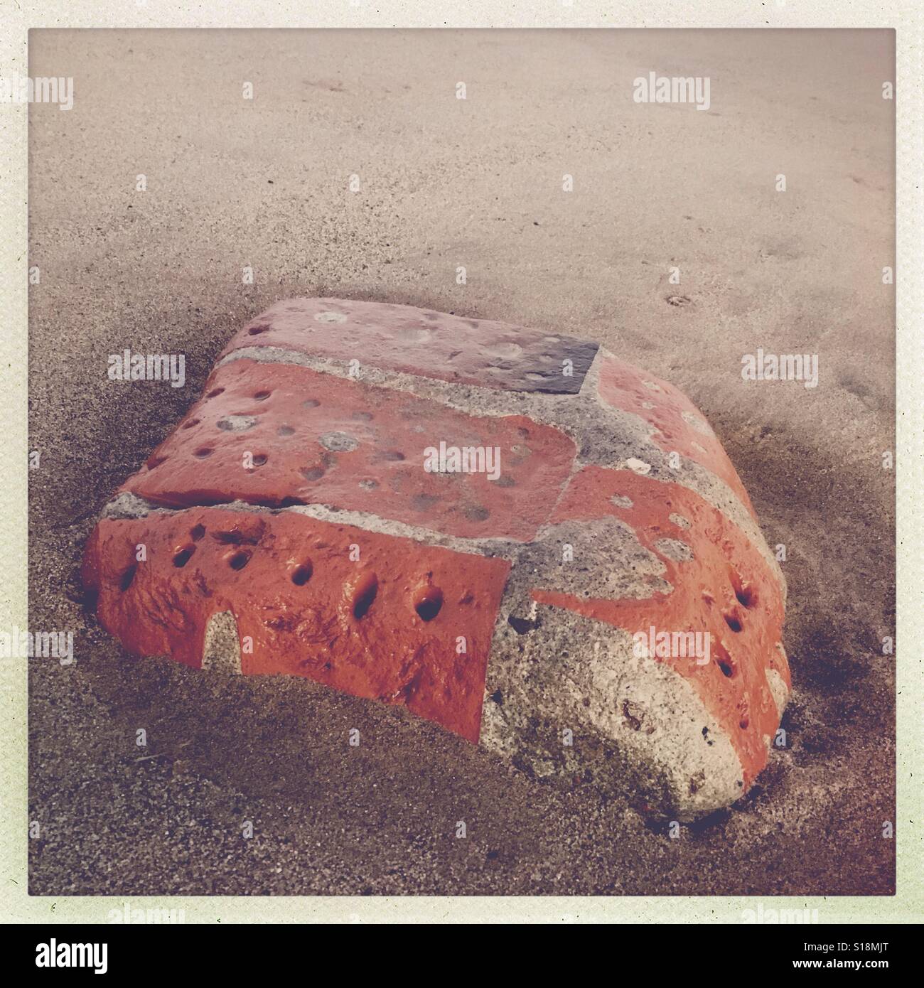 Part of an old brick wall on a sandy beach Spurn Head, Humberside, UK - Smartphone Captured Stock Image
