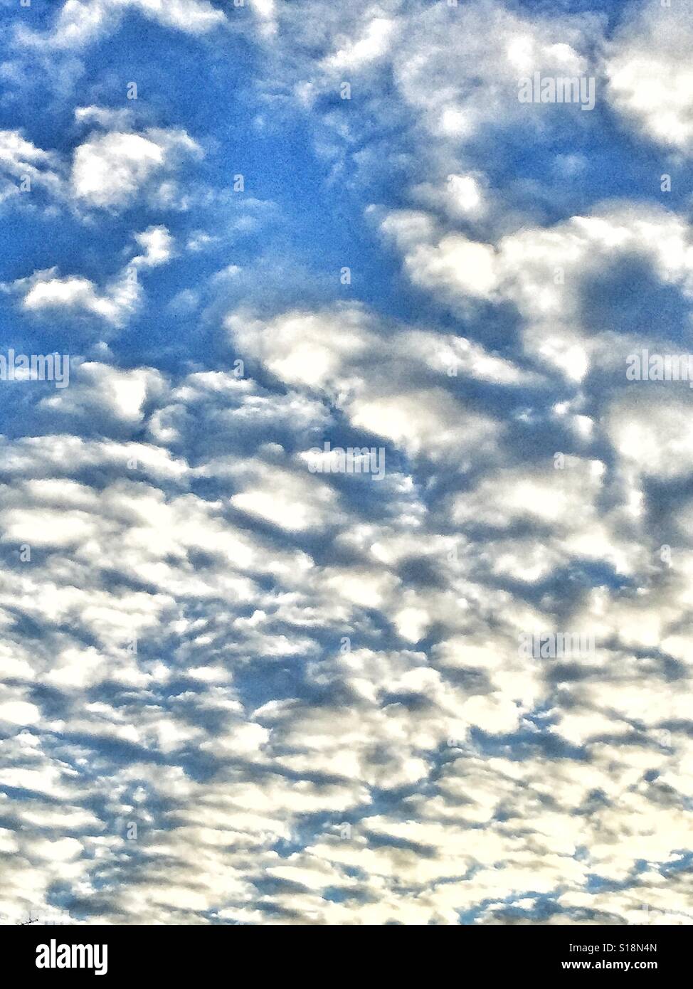 White clouds against a blue sky. Stock Photo