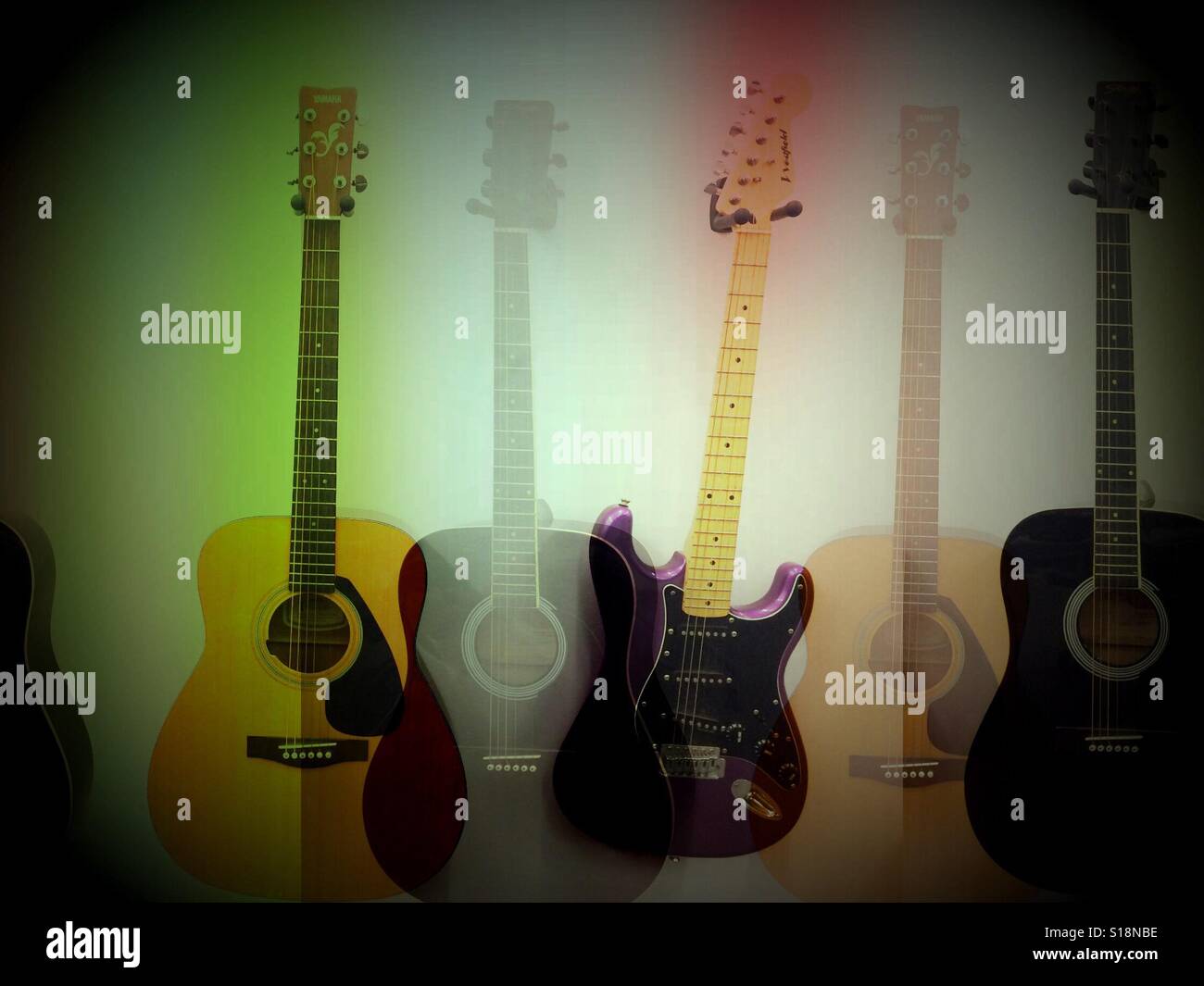 Guitars hanging on wall Stock Photo Alamy