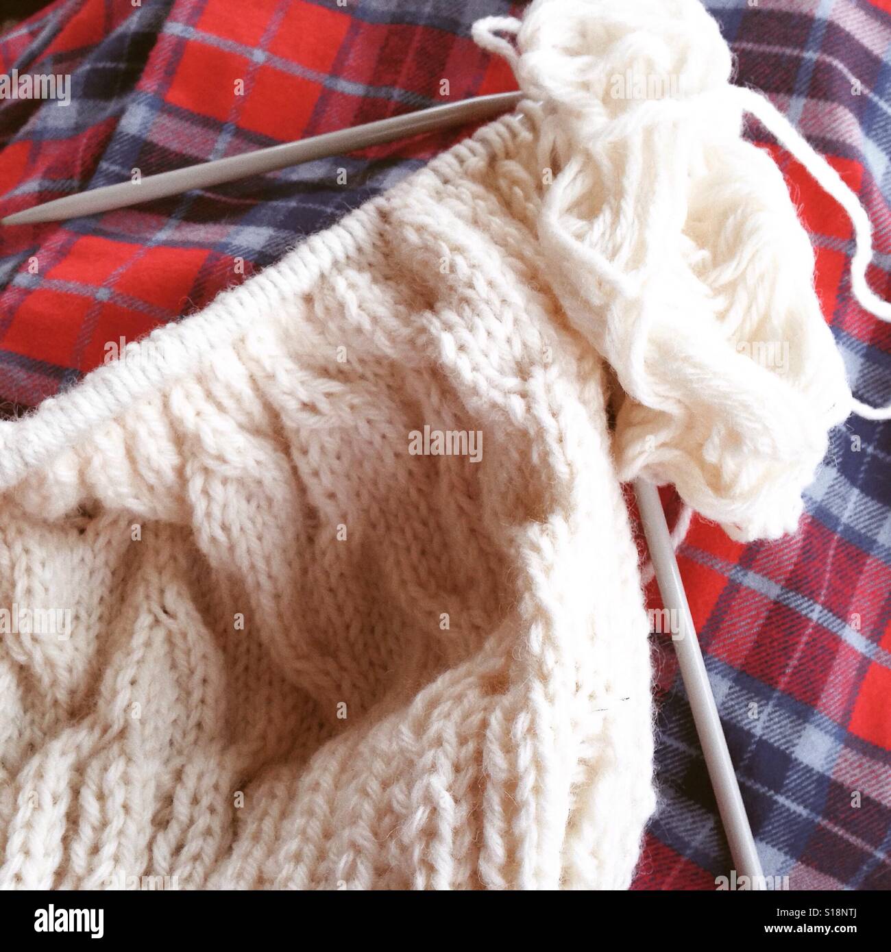Knitting in pyjamas Stock Photo