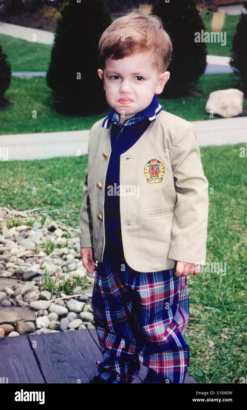 A portrait of a toddler boy dressed in a suit making a comical face - Smartphone Captured Stock Image