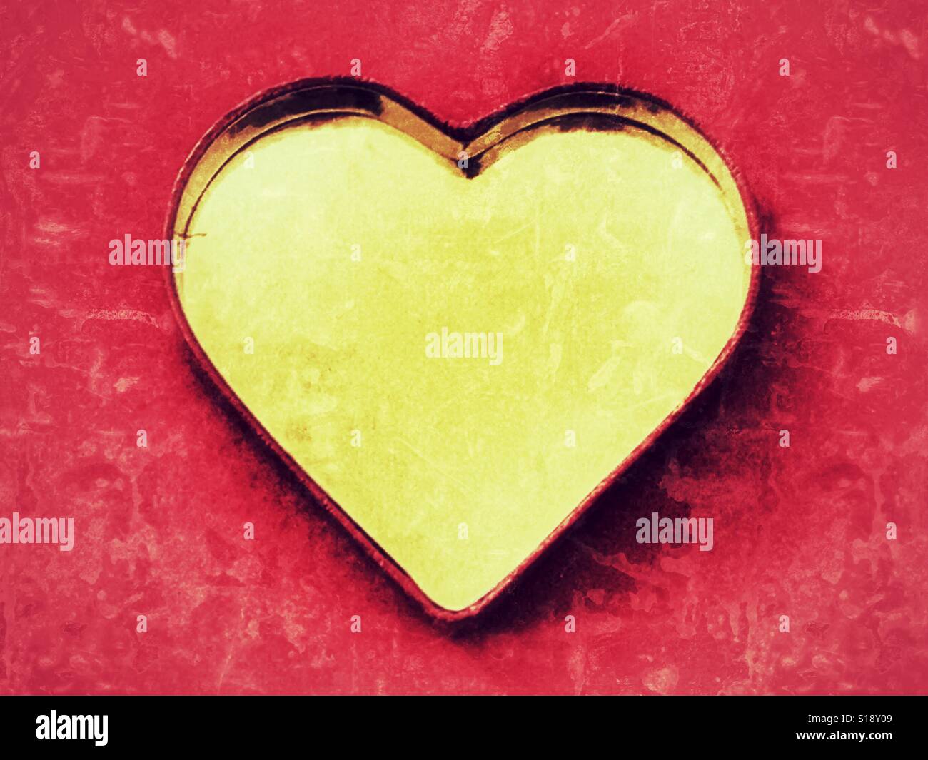 Gold heart on red - Smartphone Captured Stock Image