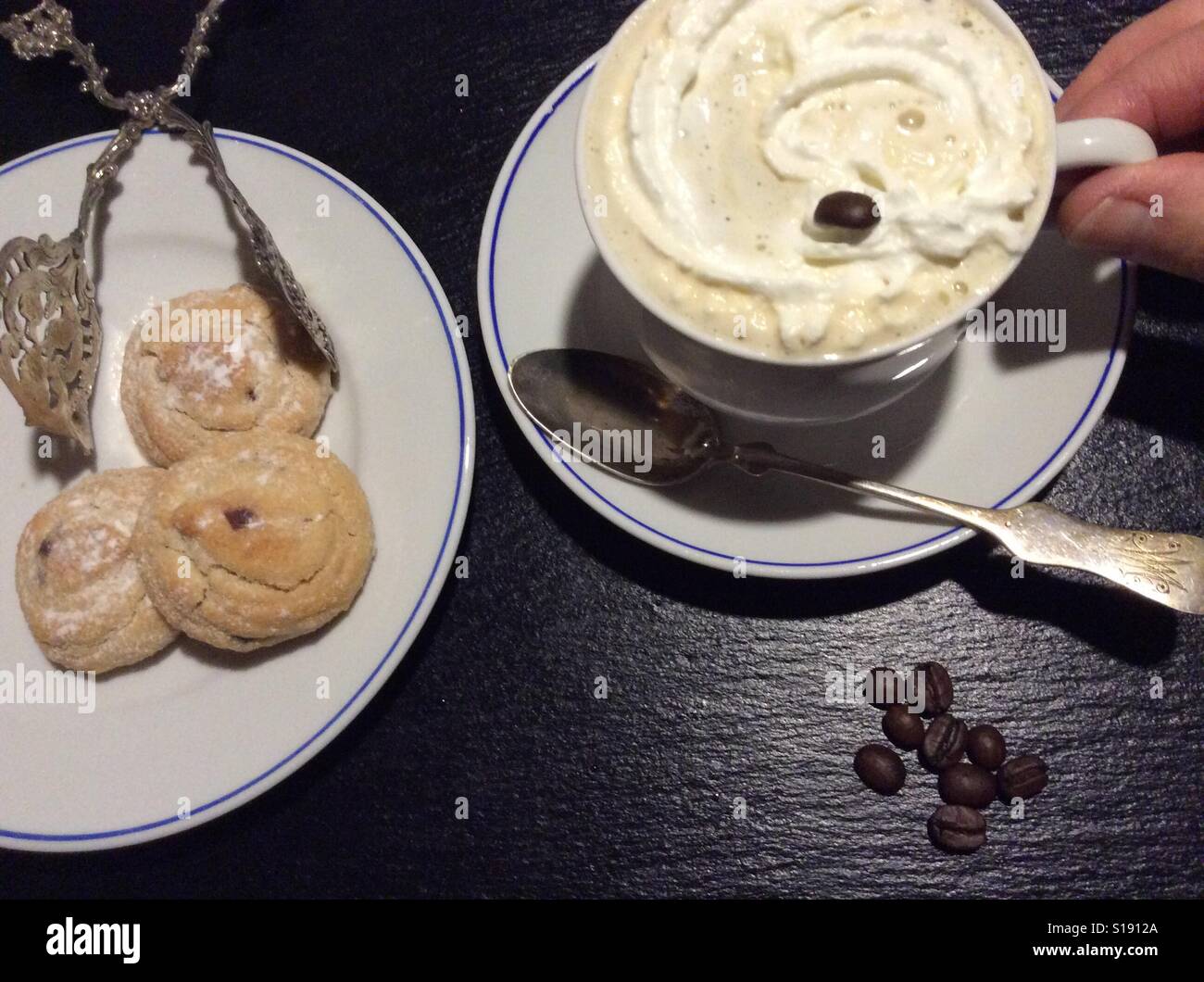 Coffee with whipped cream and cookies. POV Stock Photo