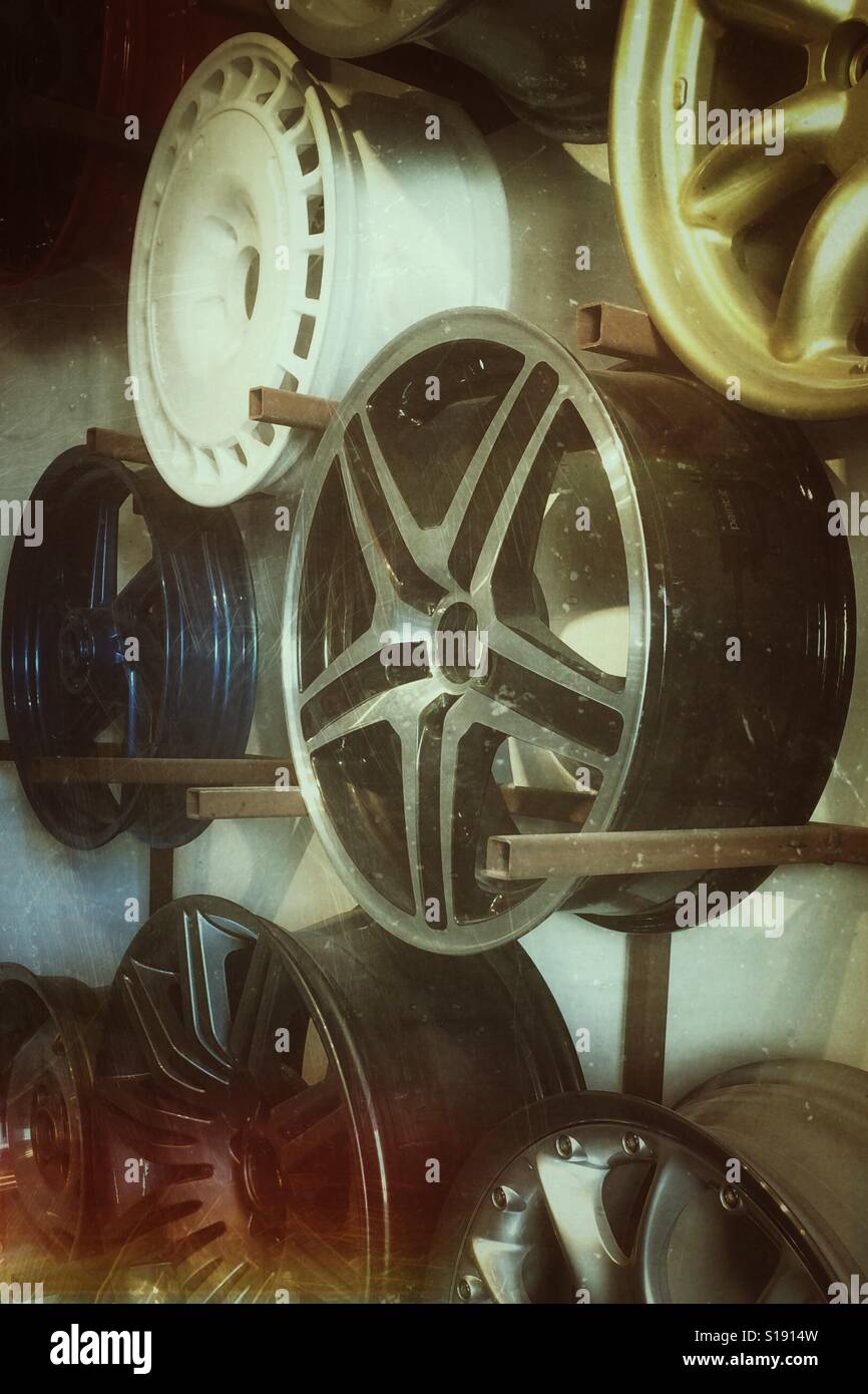 Alloy wheel hubs hanging in a workshop. - Smartphone Captured Stock Image