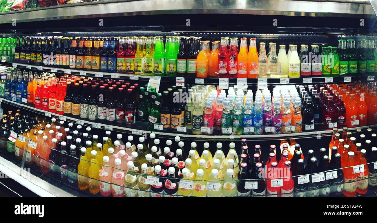 Panoramic photo of a lot of soda bottles in a cooler case at a local grocery store Stock Photo