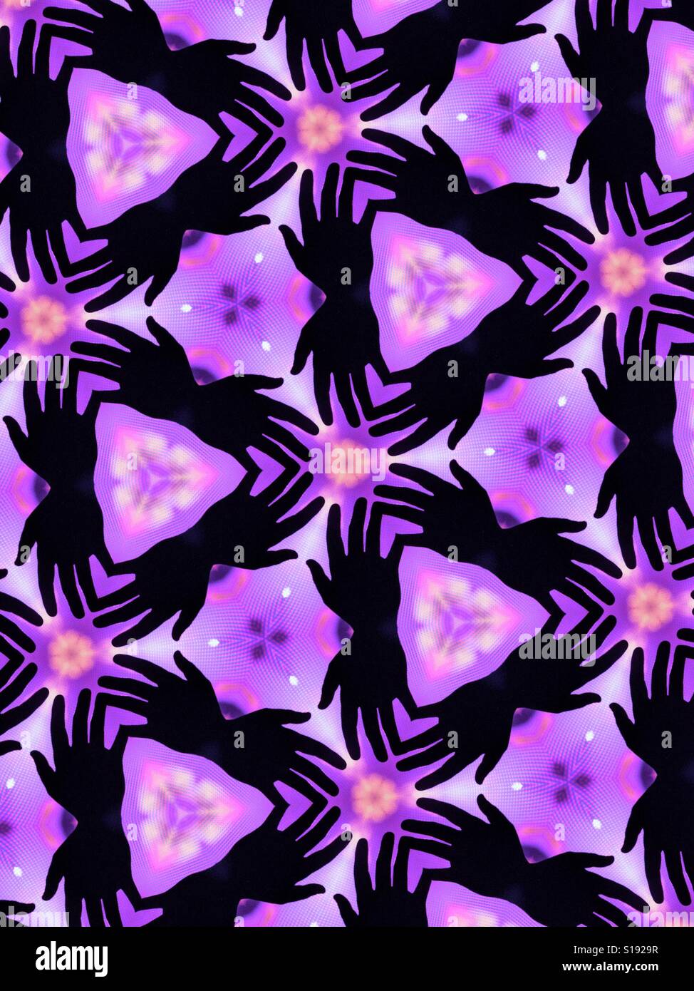 An abstract kaleidoscopic image of silhouetted outstretched hands against a purple background Stock Photo