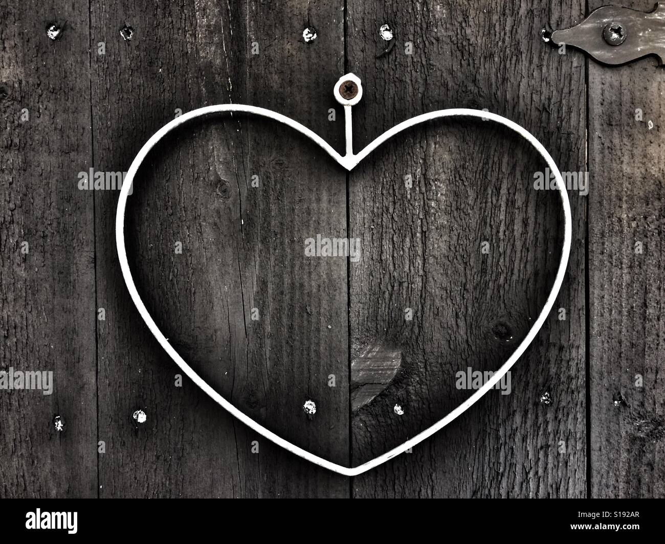 Heart of iron on wooden door Stock Photo