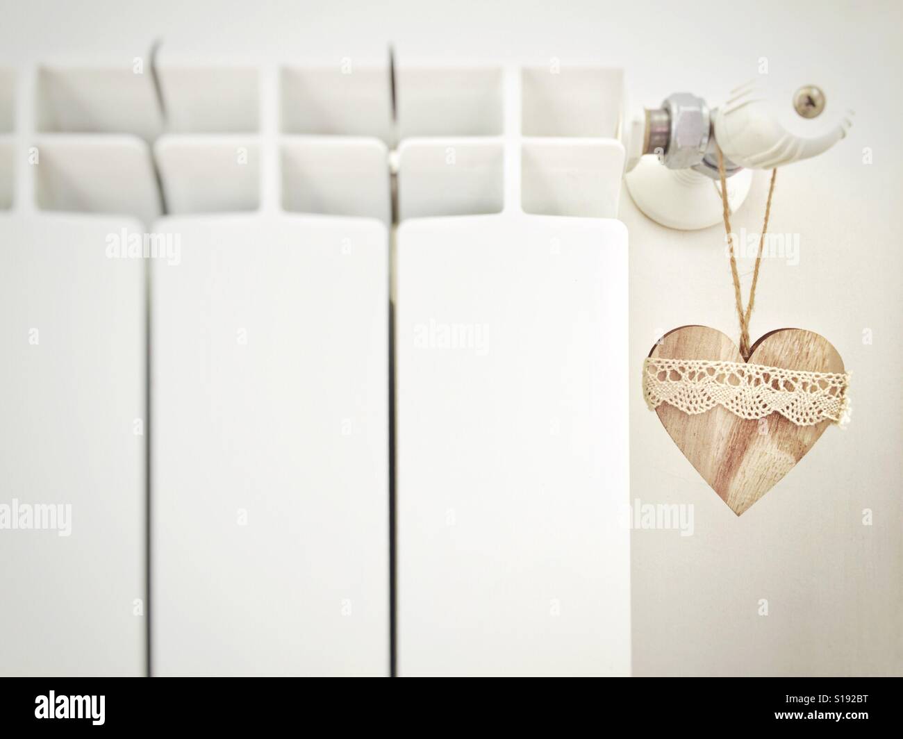 Wooden heart hanging from a radiator - Smartphone Captured Stock Image