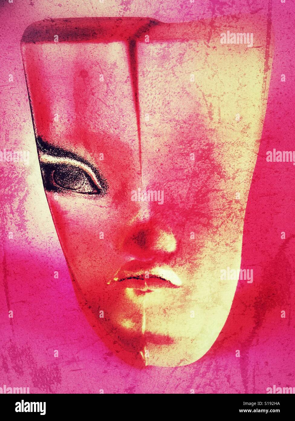 Red and pink treatment of a Mats Jonasson glass sculpture of a woman's face  or mask Stock Photo - Alamy