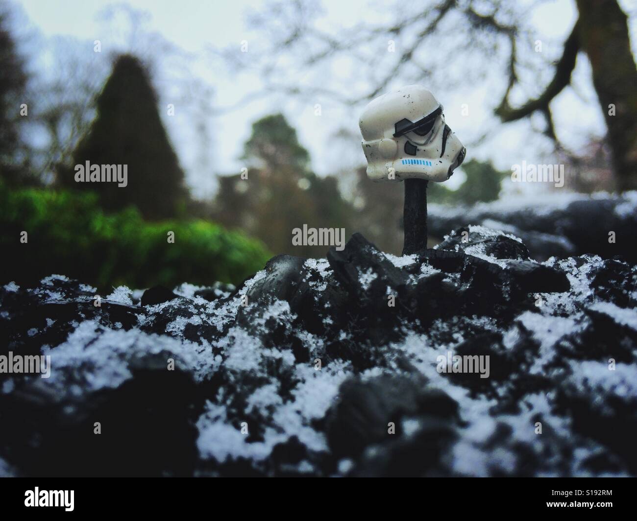 Lego Star Wars storm trooper helmet on stick, in snowy landscape. A warning to The Galactic Empire. Stock Photo