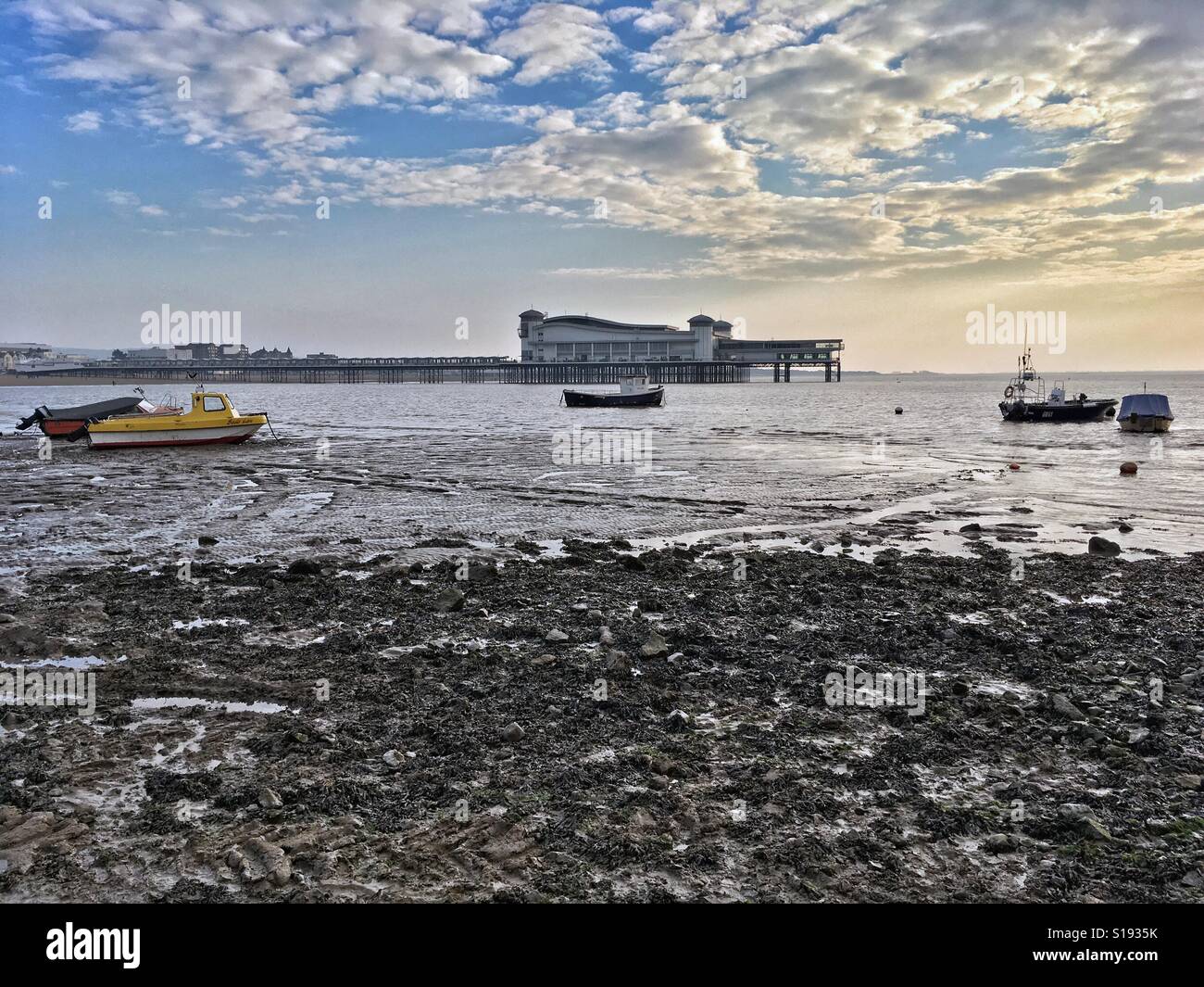 Boats left stranded by the receding tide on a winter afternoon at Weston-super-Mare, UK Stock Photo