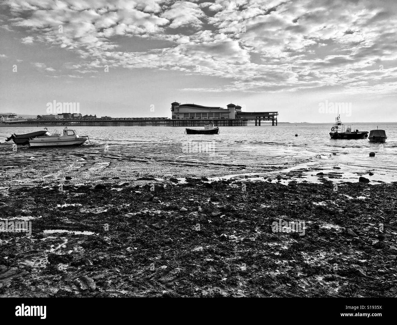 Boats left stranded by the receding tide on a winter afternoon at Weston-super-Mare, UK Stock Photo