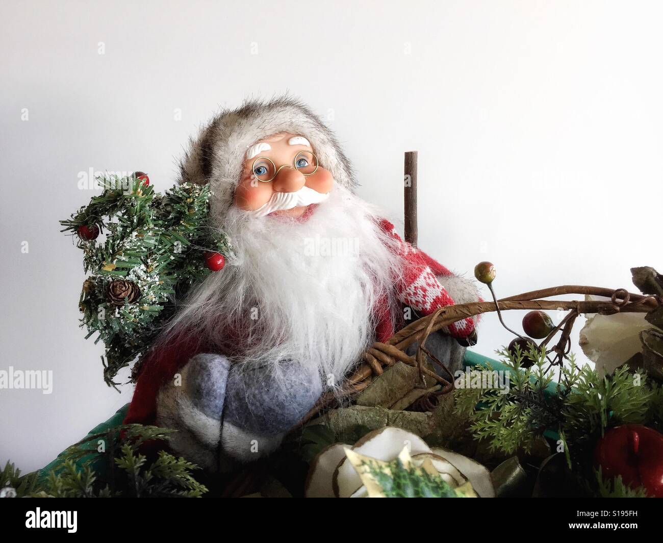 Santa Claus carrying Christmas tree in box of Christmas decorations. - Smartphone Captured Stock Image