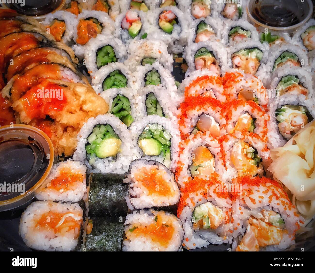 Freshly prepared assortment of sushi rolls on a platter. - Smartphone Captured Stock Image