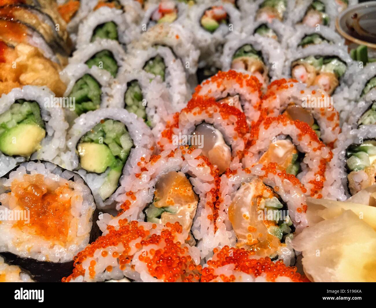 Assortment of freshly prepared sushi rolls. - Smartphone Captured Stock Image