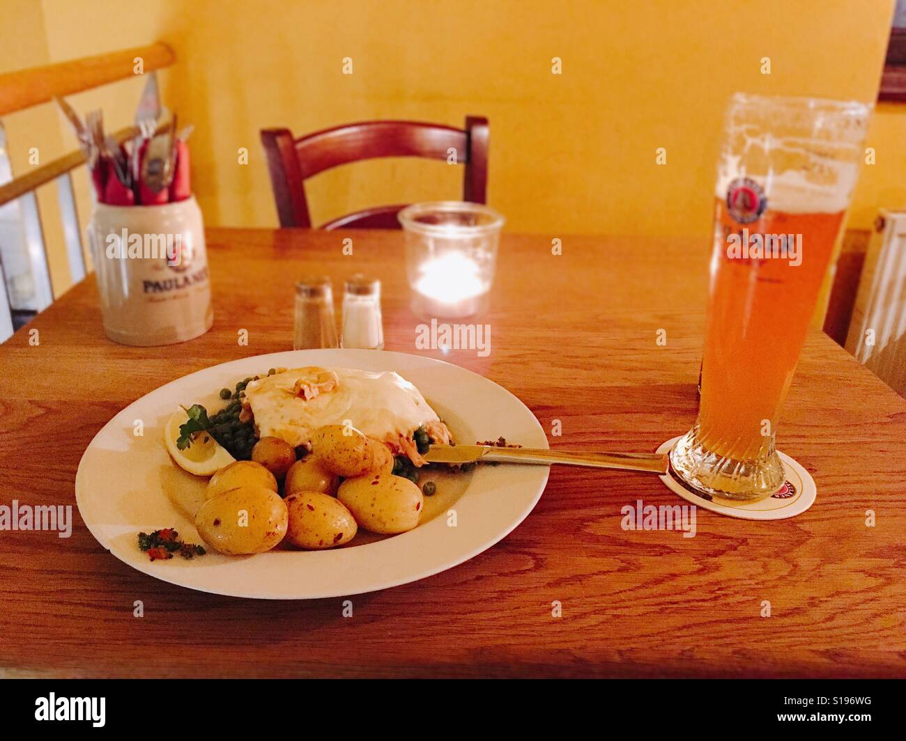 Pork steak covered with pork stew and cheese , peas and sweet potatoes