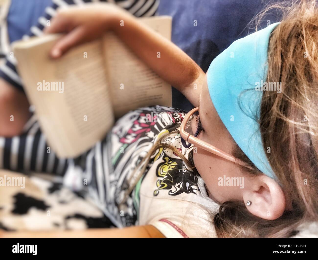Girl reading a book. - Smartphone Captured Stock Image