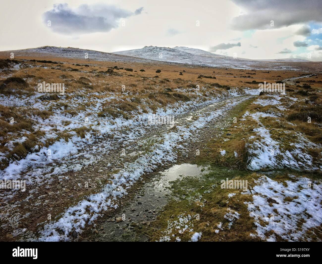 Snowy winter track leading towards Row Tor, left, and West Mill Tor, in Dartmoor National Park, Devon, UK. Stock Photo