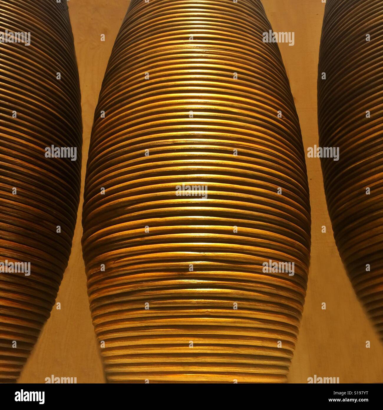 A close up photo of three large cases with bands of rattan around them - Smartphone Captured Stock Image